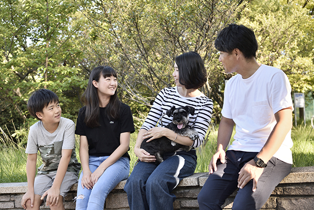 緑の多い公園で愛犬と過ごす、S様ファミリー。